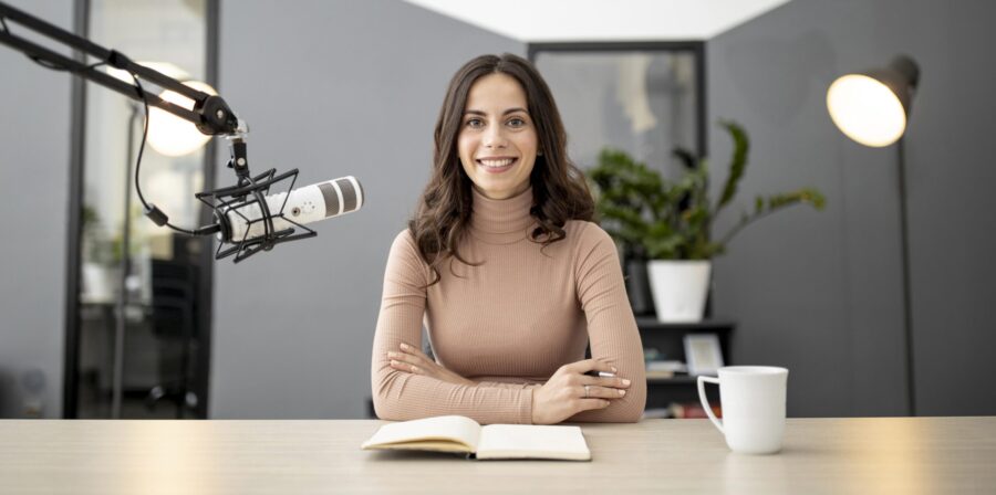 front-view-smiley-woman-radio-with-microphone-notebook